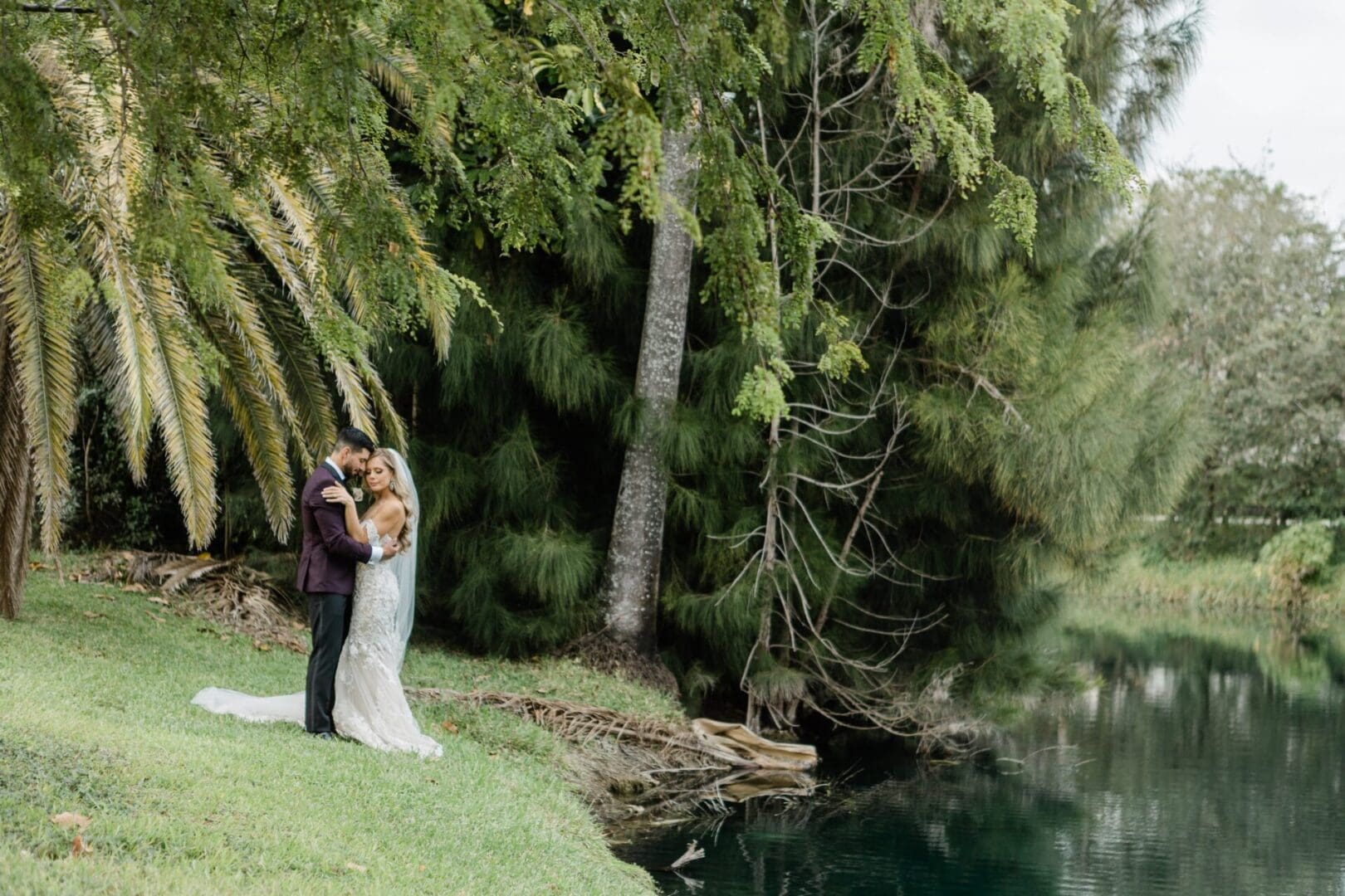 A couple is standing next to the water