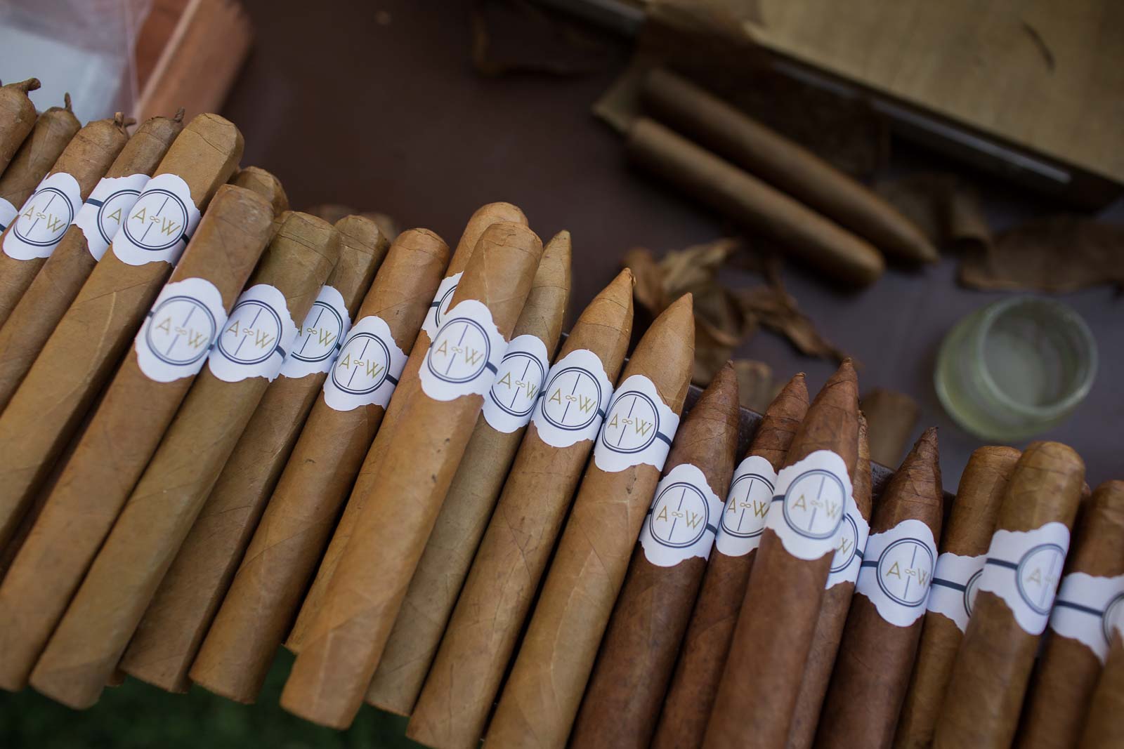 A close up of some cigars with a few on the side