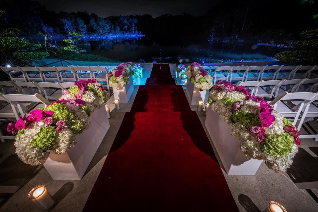A red carpet is leading to the entrance of a wedding.