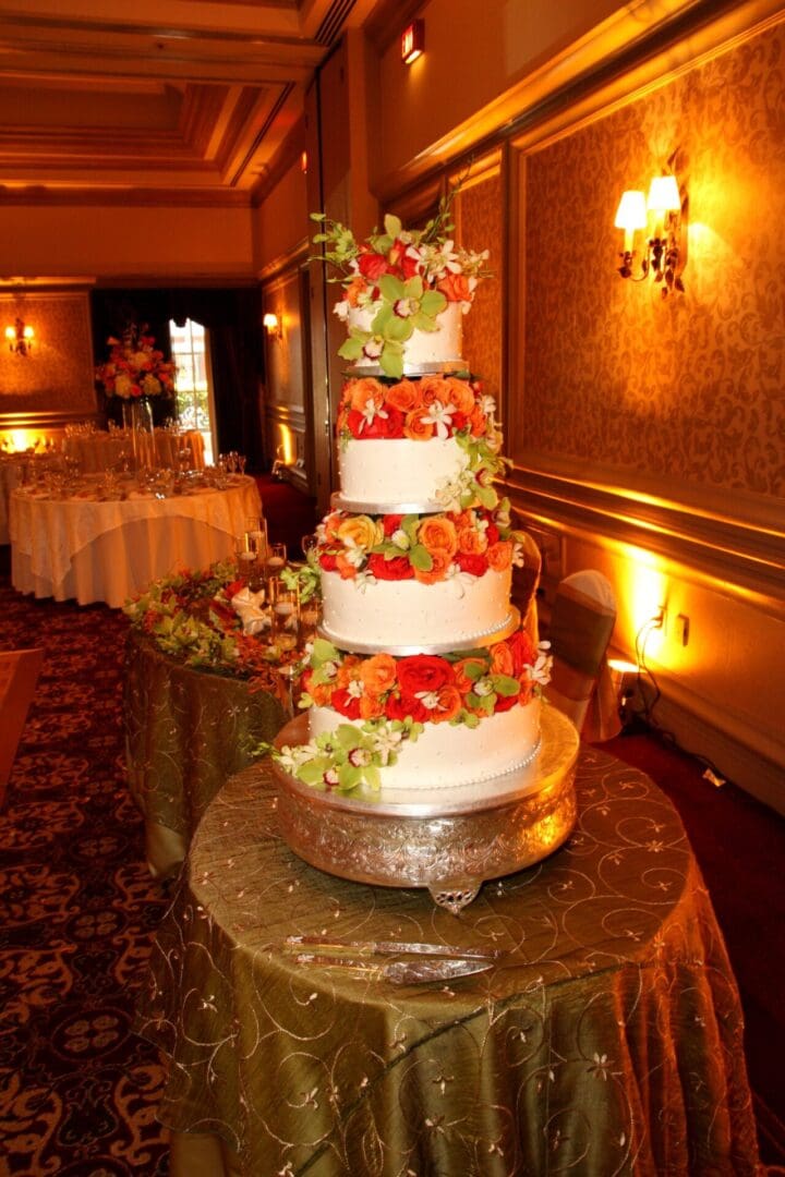 A wedding cake with fruit on top of it.