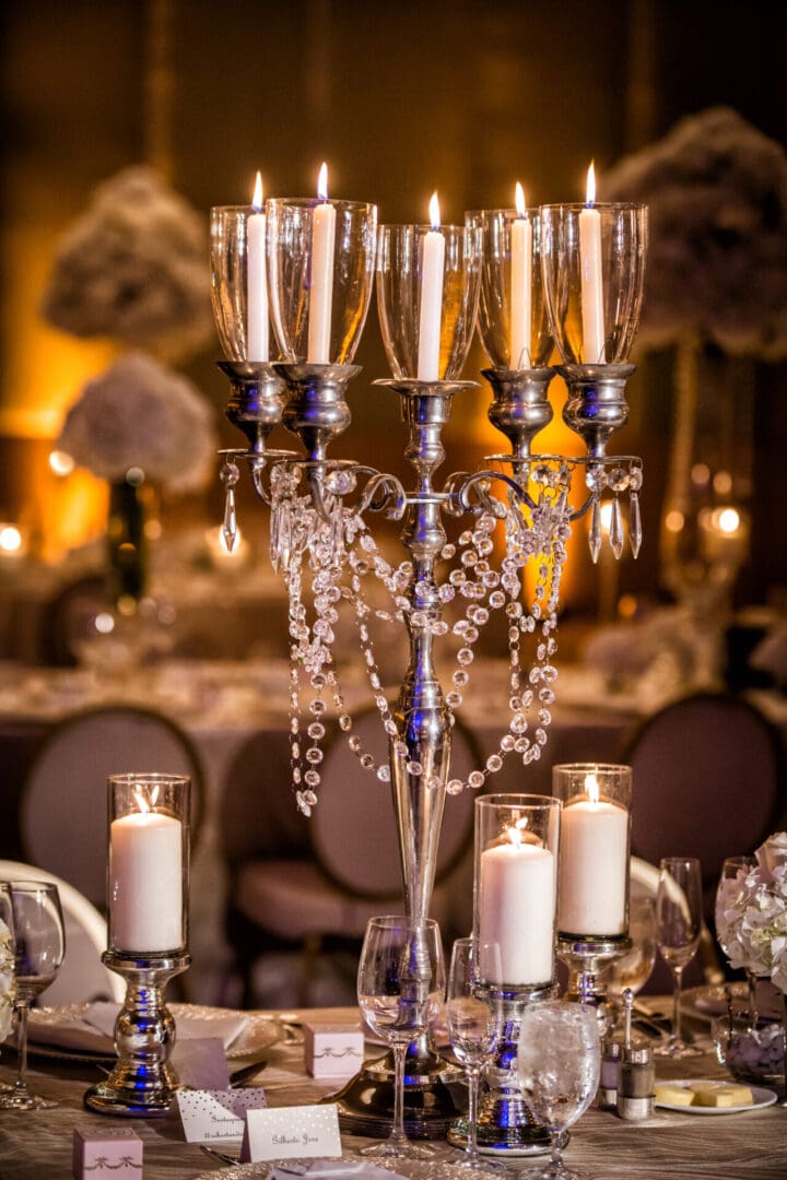 A table with candles and crystal candelabra.