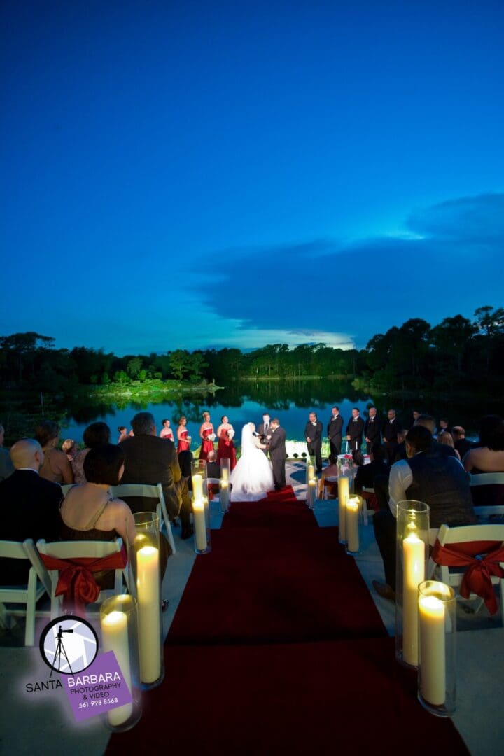 A wedding ceremony on the water at night.